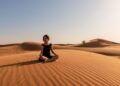 Peaceful desert meditation and yoga session at Dubai digital detox destinations like Al Maha Resort, representing screen-free wellness retreats focused on mindfulness, nature immersion, and mental clarity