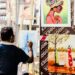 A designer works at a wooden table inside a warehouse studio that forms part of the Dubai design scene at Alserkal Avenue