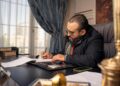 businessman-dubai-office-calendar-pexels-1 - DUBAIwebzine A Dubai startup founder reviews the Islamic New Year business calendar at his office desk in DIFC