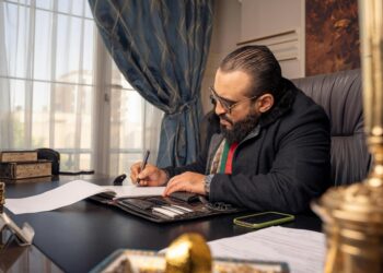 A Dubai startup founder reviews the Islamic New Year business calendar at his office desk in DIFC