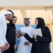 entrepreneur_signing_business_documents_Dubai - DUBAIwebzine A startup founder completes free zone registration paperwork at a modern Dubai business center