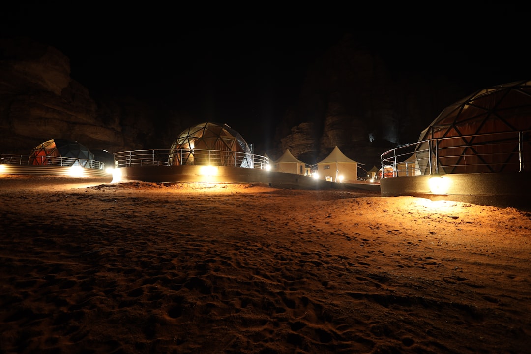 A family relaxing outside a luxury glamping dome on a desert escape near Dubai under a clear night sky
