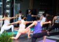 A group of women in an indoor yoga studio class in Dubai, a popular way to stay active when outdoor exercise is not possible