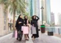 ladies_shopping_in_Dubai - DUBAIwebzine ladies exploring deals inside a Dubai mall during Dubai Summer Surprises, surrounded by colourful festival promotions.