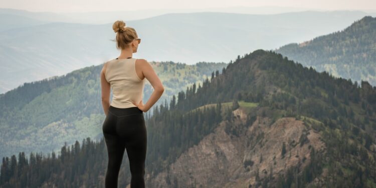 mountain-hiking-woman-unsplash - DUBAIwebzine A woman hiking a rocky mountain trail on one of the best day trips from Dubai to Jebel Jais in Ras Al Khaimah