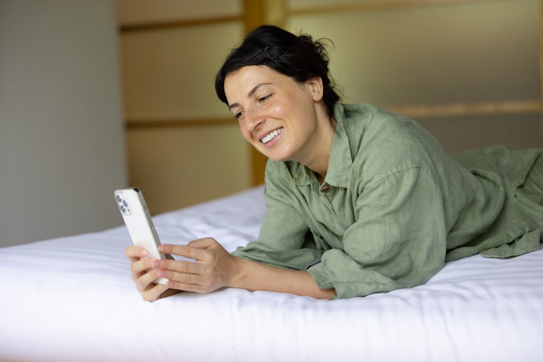 A woman browsing her phone to book a staycation, planning to use Dubai discounts on spa and dining offers