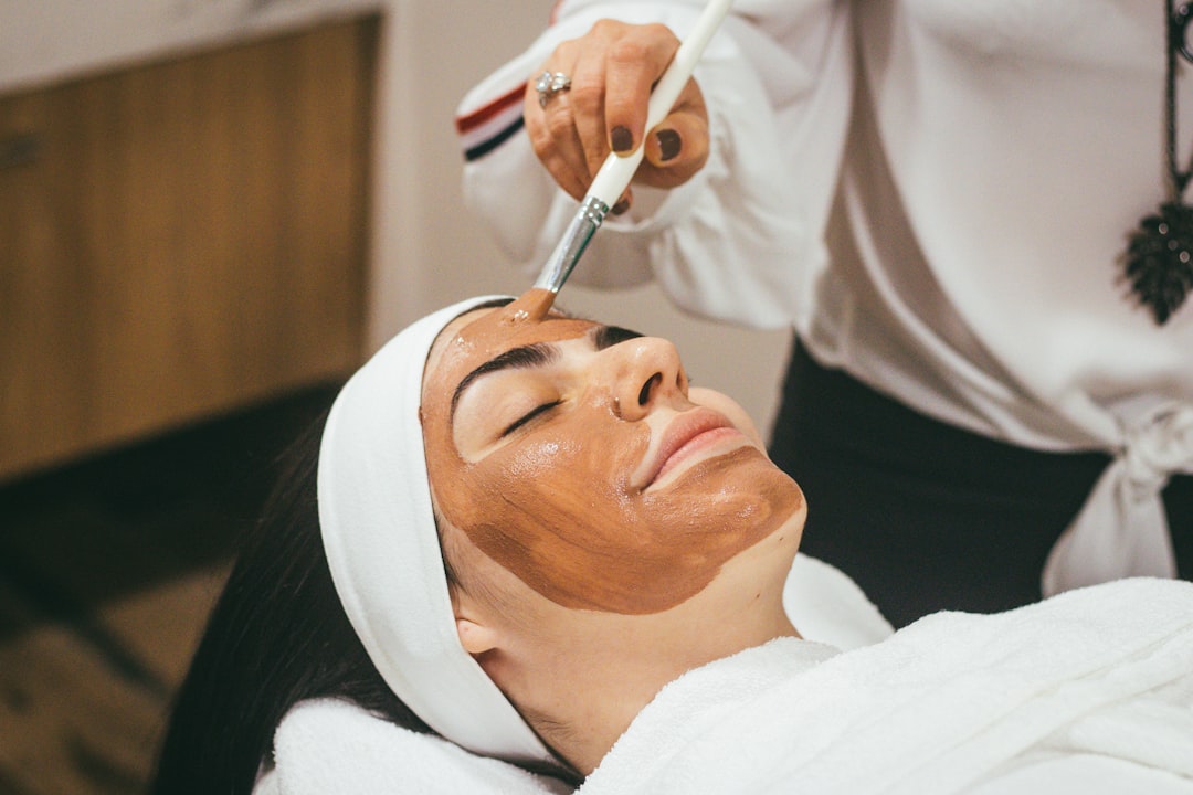 A therapist performing a facial on a client at an indoor wellness retreat in Dubai