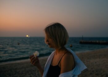 A visitor walks along Dubai Creek during the Hijri New Year long weekend, with the water behind her.