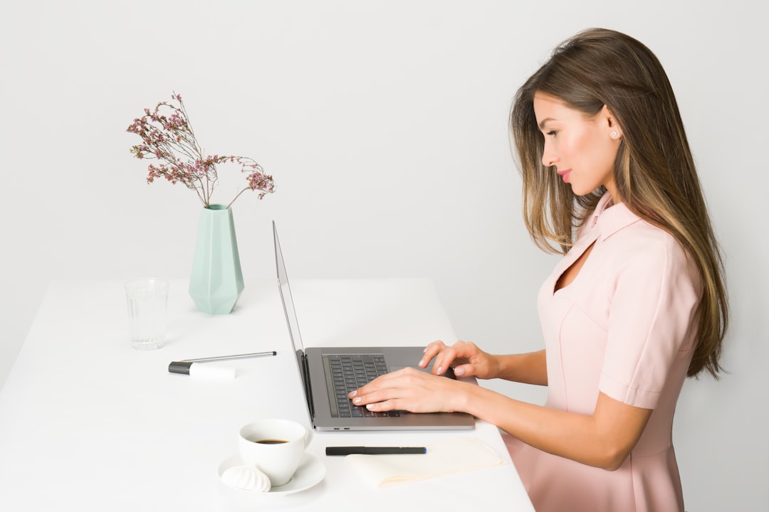 A founder checks her free zone registration status online from her Dubai co-working space