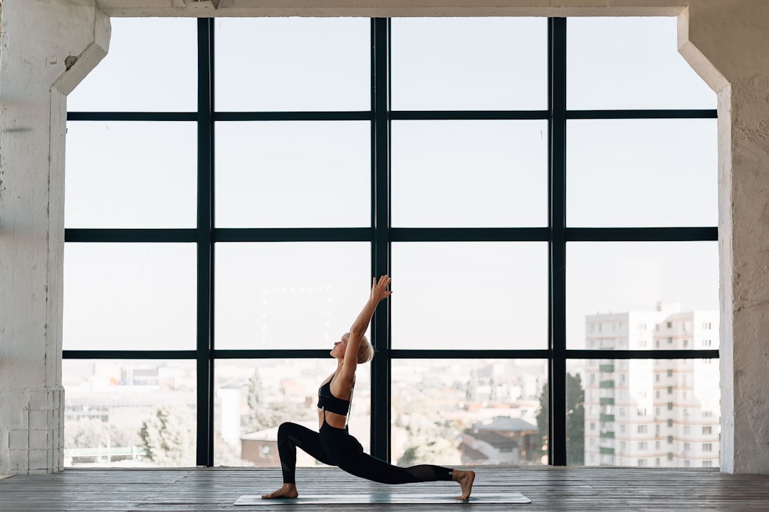 A woman practicing yoga inside a calm indoor wellness space in Dubai