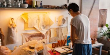 artist-studio-workspace-unsplash - DUBAIwebzine A painter works in a sunlit studio space during one of the art residencies available to Dubai residents this summer