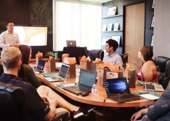A business mentor and startup founder review a growth strategy together in a Dubai coworking space