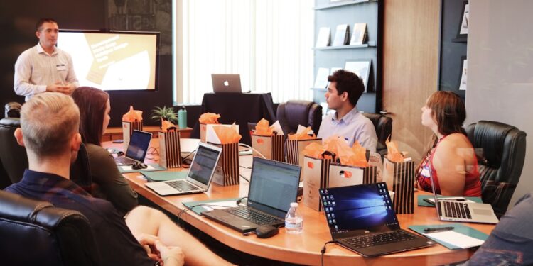 business-meeting-professional-unsplash - DUBAIwebzine A business mentor and startup founder review a growth strategy together in a Dubai coworking space