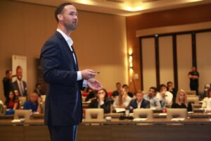 A professional man speaking in conference about how Dubai liveability draws top global talent