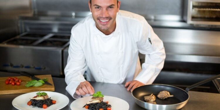 A professional chef presents a certified gluten-free dining dish at a fine restaurant in Dubai