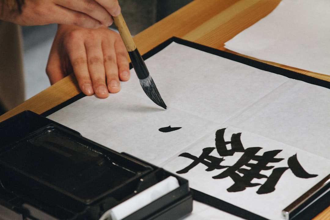 Children practising Arabic calligraphy with a teacher as part of workshops designed to connect kids to cultural heritage.
