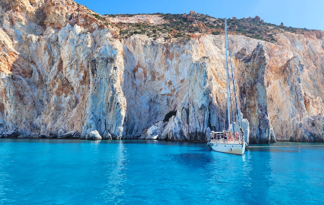 A couple enjoying a boat trip near Santorini, one of the most popular summer flights destinations from Dubai