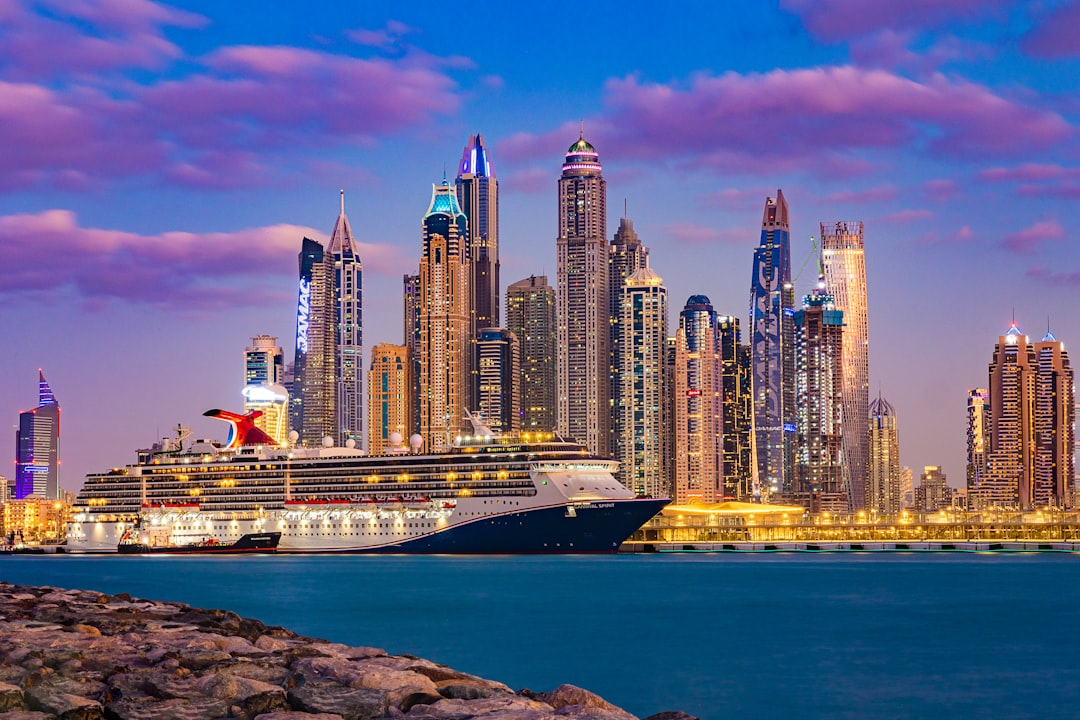 Workers at a Dubai port container terminal handling freight amid Hormuz trade disruption