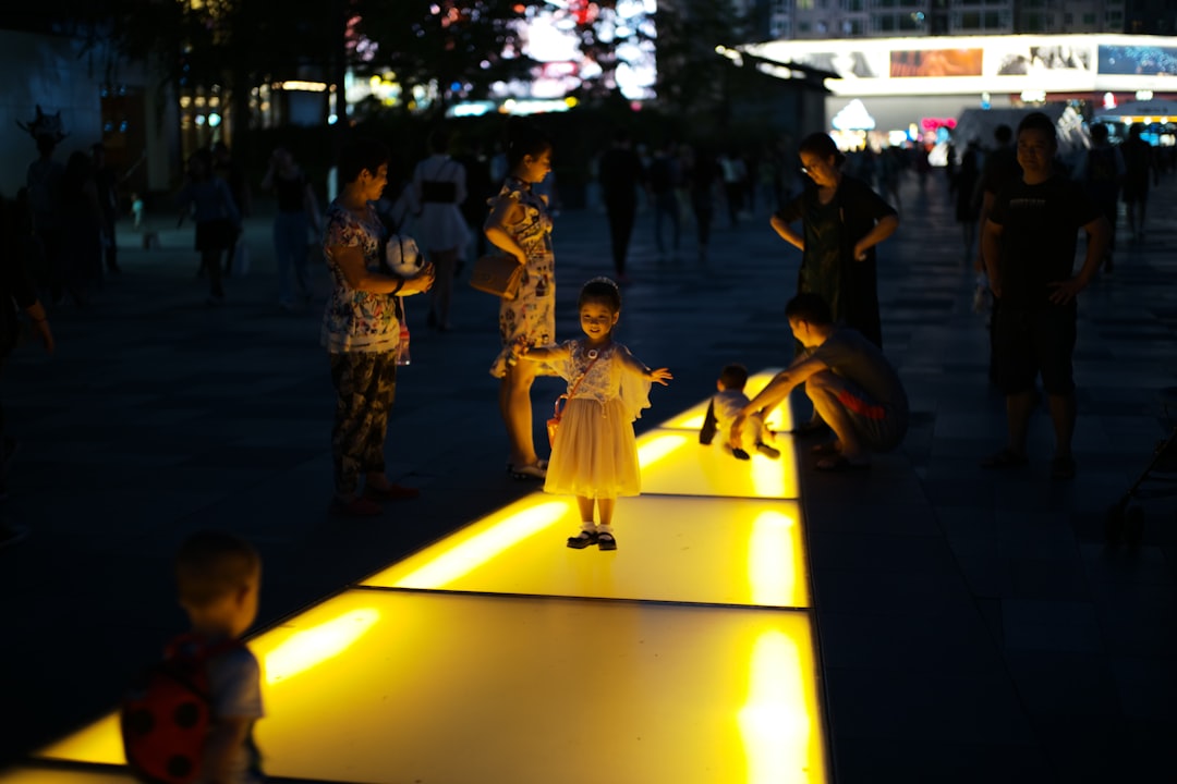 A family with children explores a colorful sensory light installation at an immersive art venue in Dubai