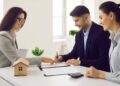 investor_signing_business_contract_ - DUBAIwebzine A global investor signing an off-plan property contract at a modern Dubai real estate office