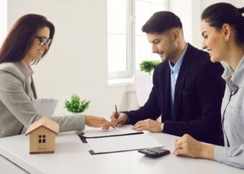 A global investor signing an off-plan property contract at a modern Dubai real estate office