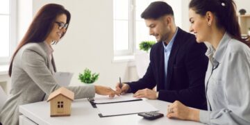 investor_signing_business_contract_ - DUBAIwebzine A global investor signing an off-plan property contract at a modern Dubai real estate office
