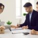 A global investor signing an off-plan property contract at a modern Dubai real estate office