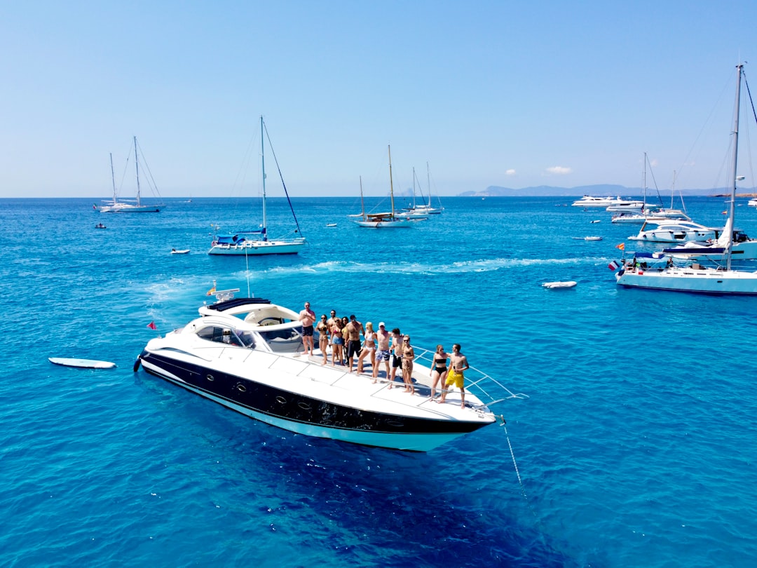 A group of guests share a gourmet meal on the deck during a private yacht charter experience in Dubai