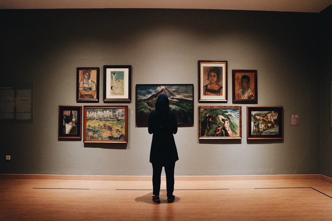 visitor explores a contemporary exhibition at one of Dubai's indoor art galleries in Al Quoz