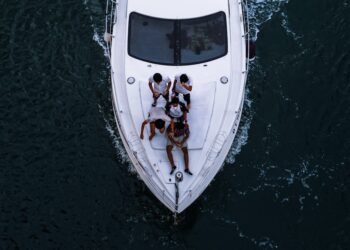 friends enjoying a private yacht charter in Dubai with the city skyline visible across the water