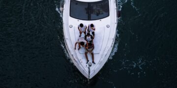 friends enjoying a private yacht charter in Dubai with the city skyline visible across the water