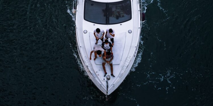 people-on-luxury-yacht-dubai-unsplash - DUBAIwebzine friends enjoying a private yacht charter in Dubai with the city skyline visible across the water