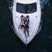 friends enjoying a private yacht charter in Dubai with the city skyline visible across the water