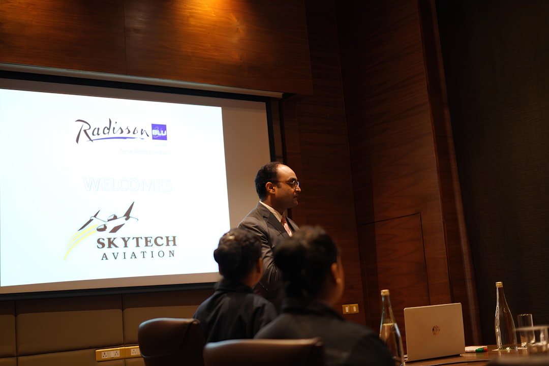 A startup founder presents an aerospace innovation pitch at a Dubai Airshow exhibitor event, connecting with investors