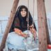 woman-arabic-traditional-coffee-unsplash - DUBAIwebzine A woman enjoys a cup of gahwa in a traditional courtyard, a central ritual of Arabic culture in Dubai
