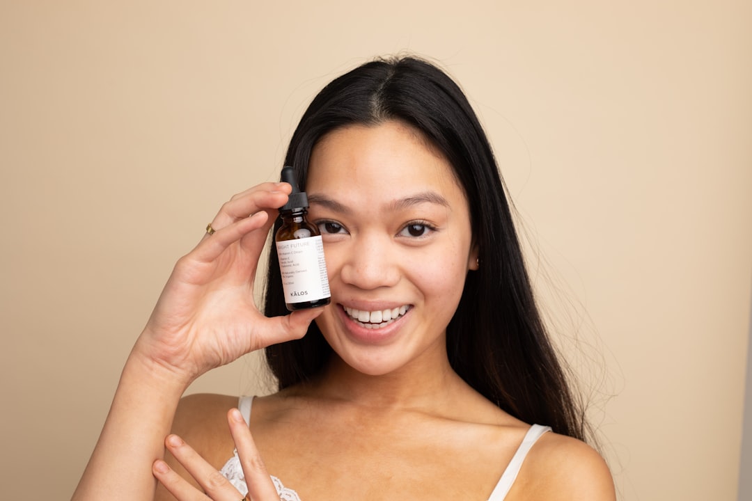 A woman examining a Dubai skincare serum bottle, reading the ingredients label with focused attention