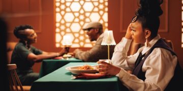 A woman enjoying a curated set menu during summer restaurant week at a Dubai restaurant