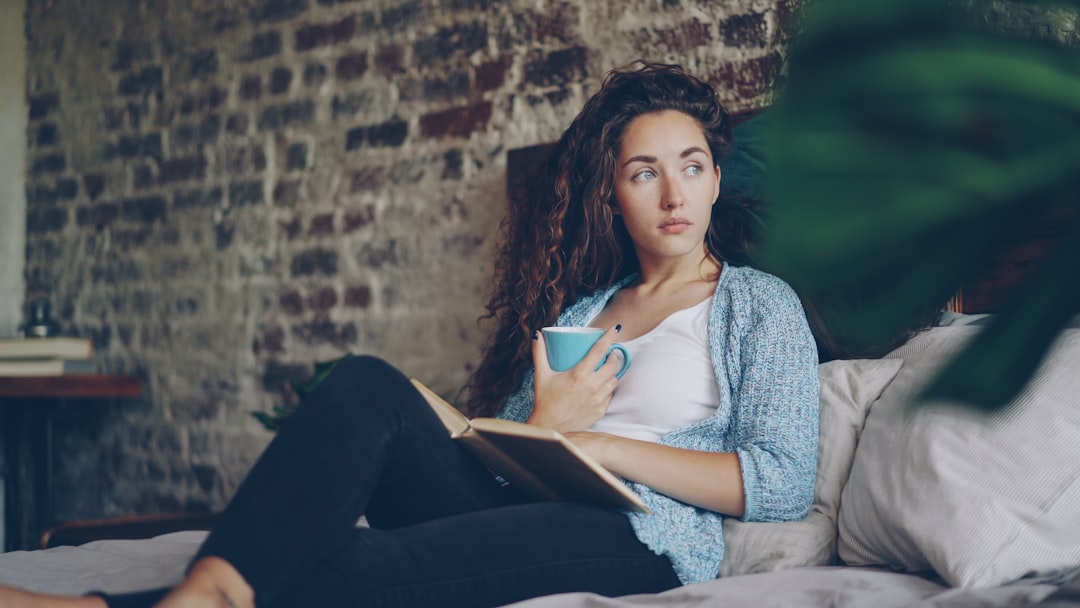 A woman writing in her journal by morning light, building a daily routine to support her mental health through Dubai summer.