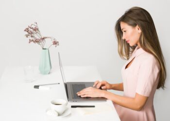 A female entrepreneur builds her personal brand strategy during Dubai's low season at a modern co-working space