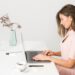 A female entrepreneur builds her personal brand strategy during Dubai's low season at a modern co-working space