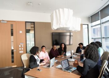 An African tech founder reviews expansion plans at a modern Dubai office, representing the growth of African tech companies.