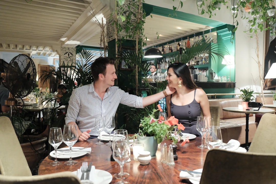 A couple in conversation at a luxury table, representing the social world of members-only dining clubs in Dubai.