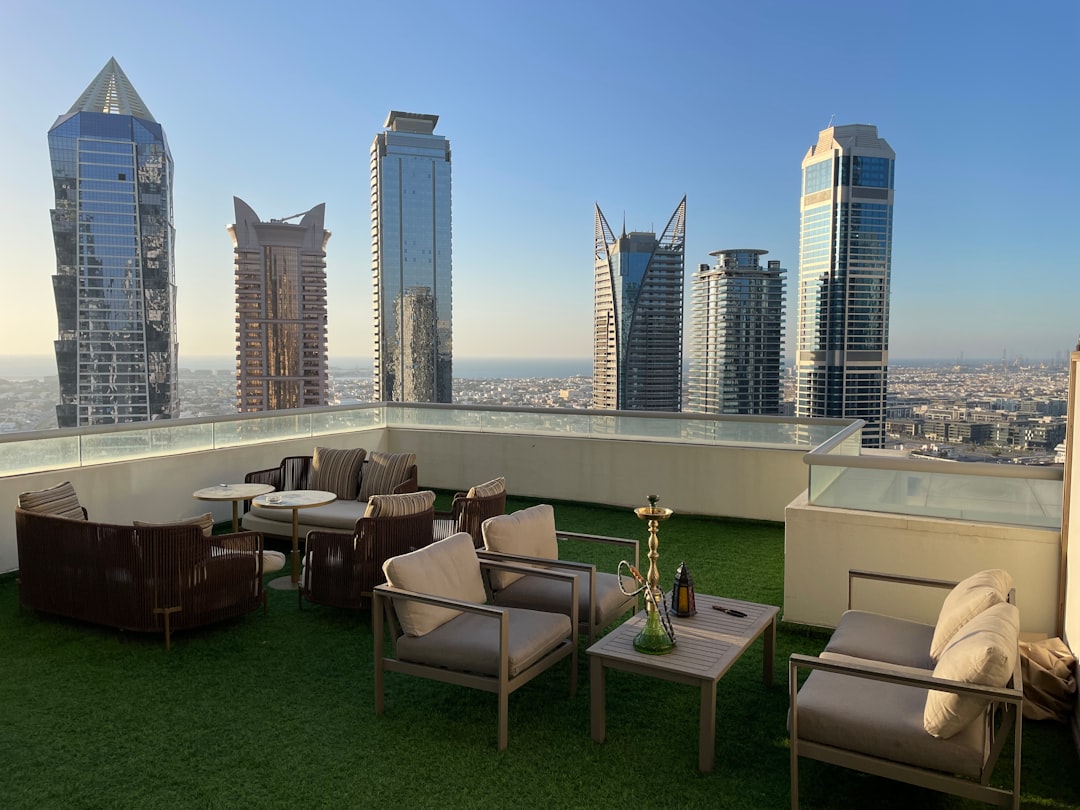 a rooftop restaurant overlooking Dubai's skyline, capturing the elevated atmosphere of members-only dining in the city.