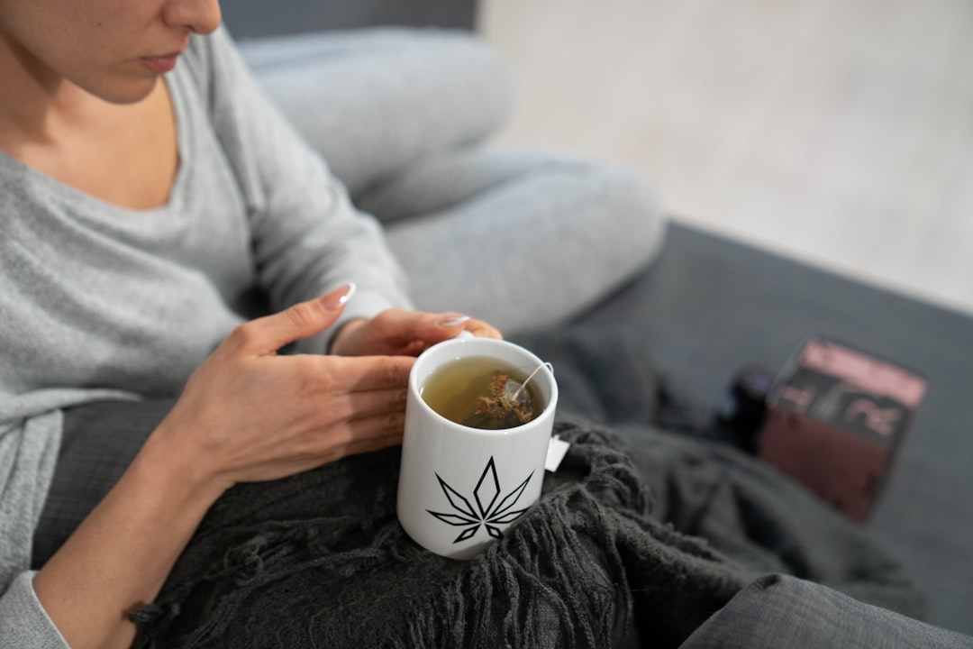 A woman winding down with a warm drink as part of her evening sleep schedule routine in the UAE