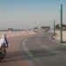 A family cycling along a beachside track in Dubai, enjoying outdoor activities together in the early morning light