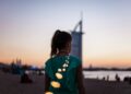 woman-dubai-opera-evening-performance-unsplash - DUBAIwebzine A woman dressed for an evening out stands in front of Dubai Opera, ready to enjoy the Dubai cultural calendar this autumn