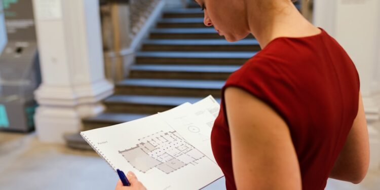 A professional investor reviews Dubai property market data and transaction reports at her desk