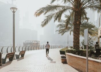 A woman running along Kite Beach in Dubai at sunrise as part of her seasonal fitness reset routine