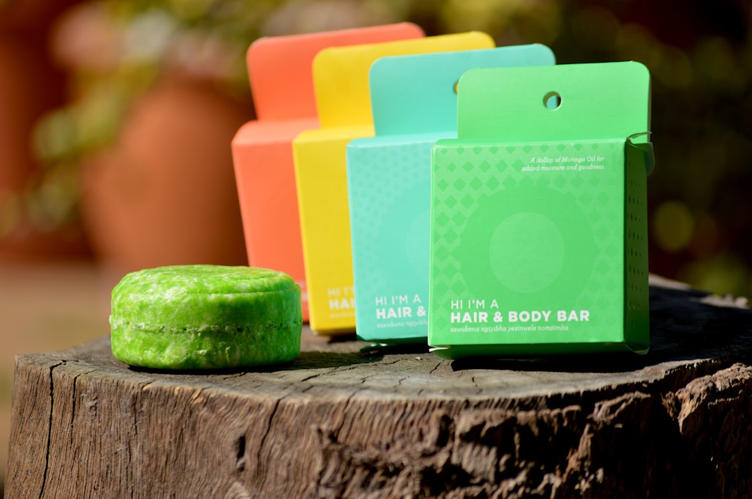 A woman holding a solid shampoo bar in a bright bathroom, making a simple swap to reduce plastic use in her daily routine